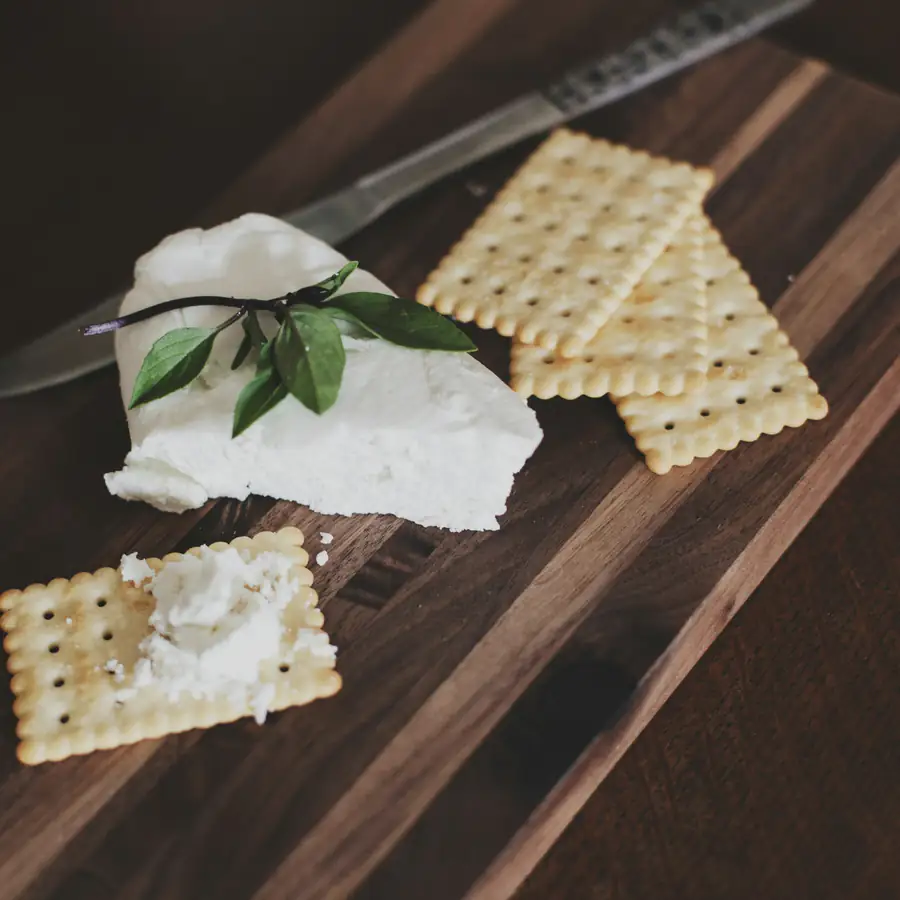 Crackers with soft cheese on a board