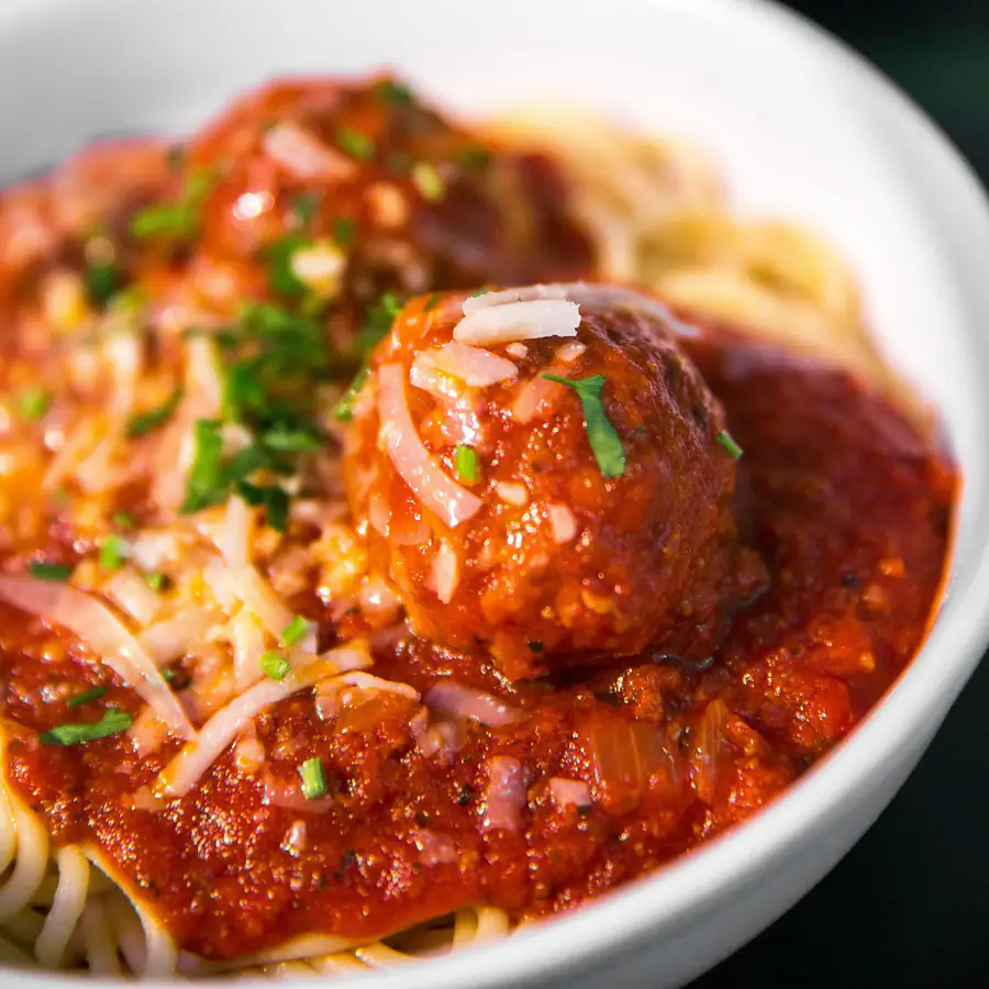 Bowl of spaghetti with meatballs in tomato sauce