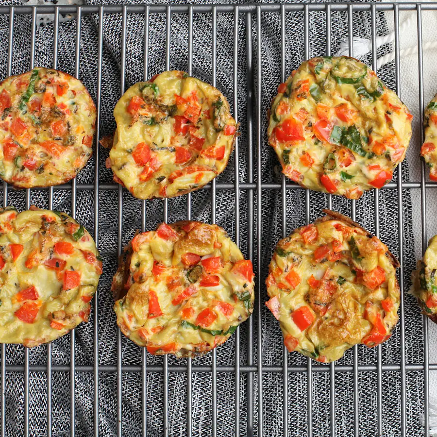 Mini vegetable quiches cooling on a rack
