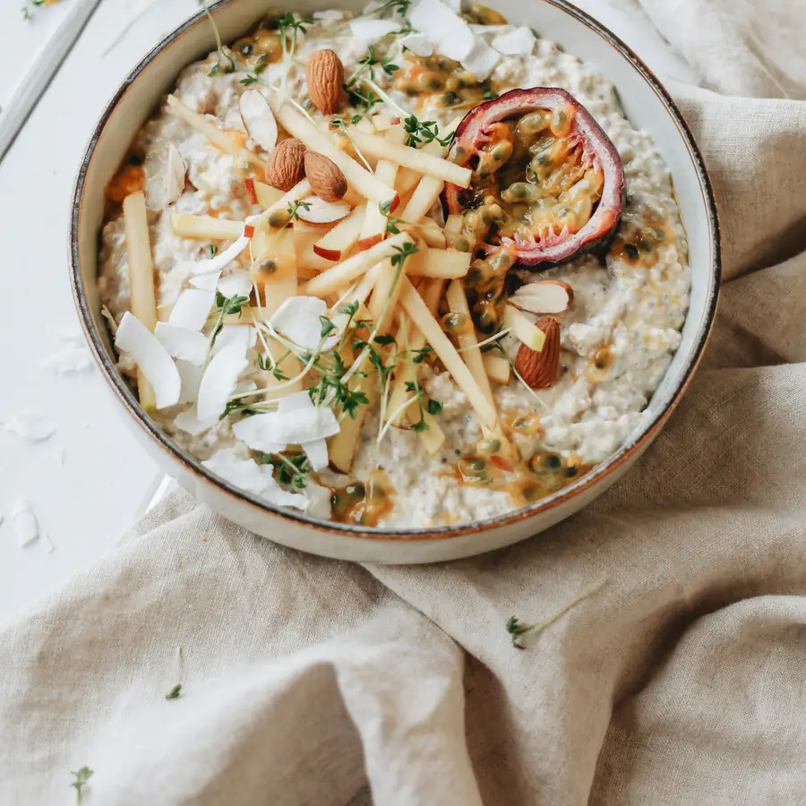Bowl of creamy porridge with fruit and nuts