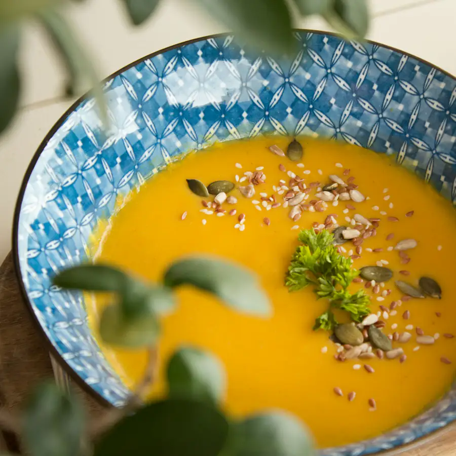 Bowl of golden red lentil dal with seeds