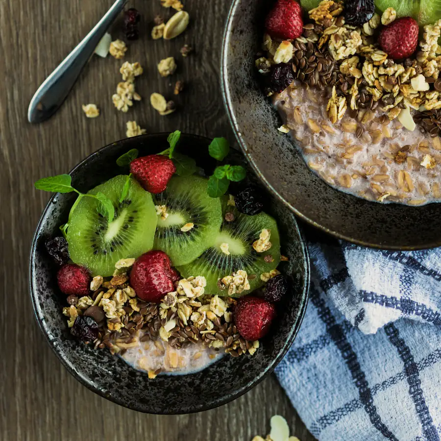 Bowl of yoghurt with kiwi, berries and seeds