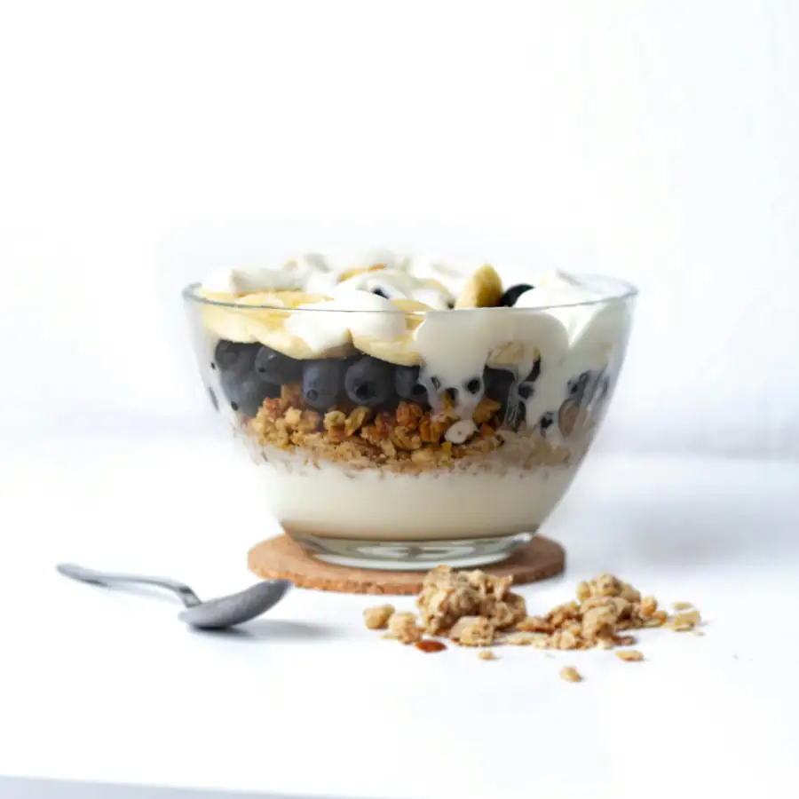 Glass of layered yoghurt oats and berries