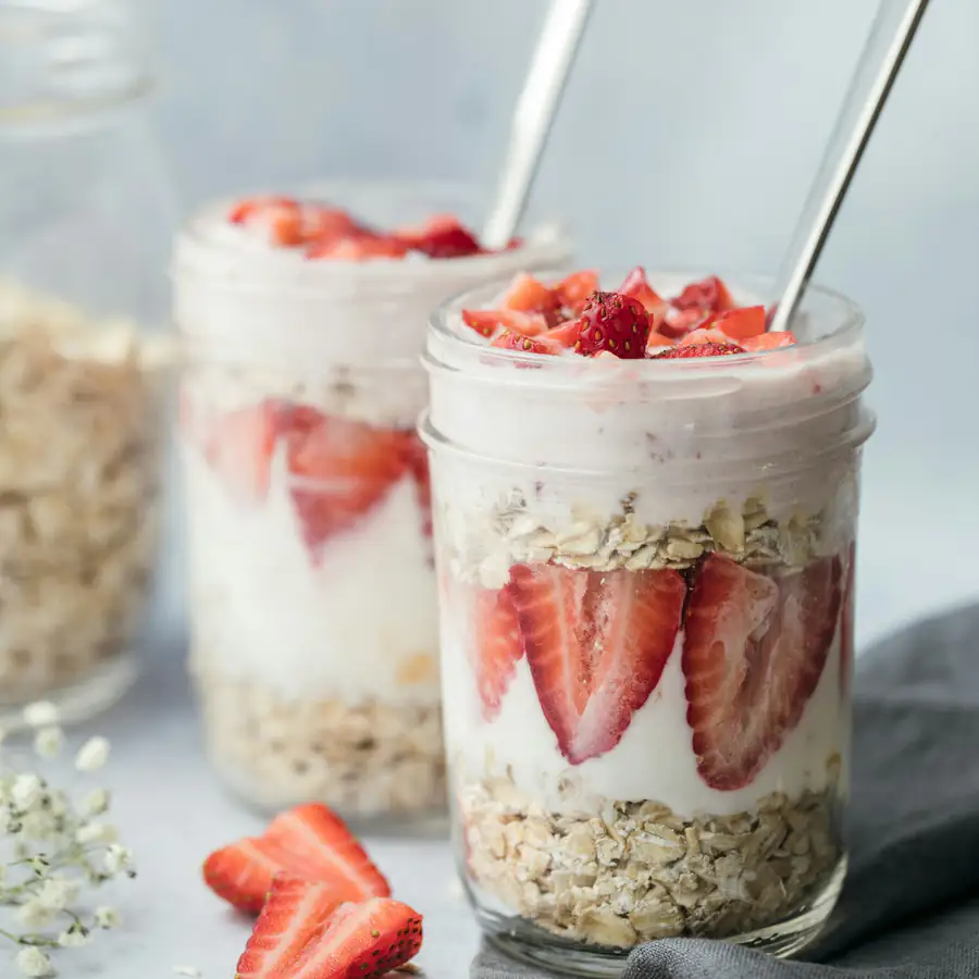 Jars of overnight oats layered with strawberries