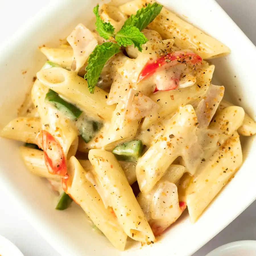 Plate of creamy chicken penne pasta with basil
