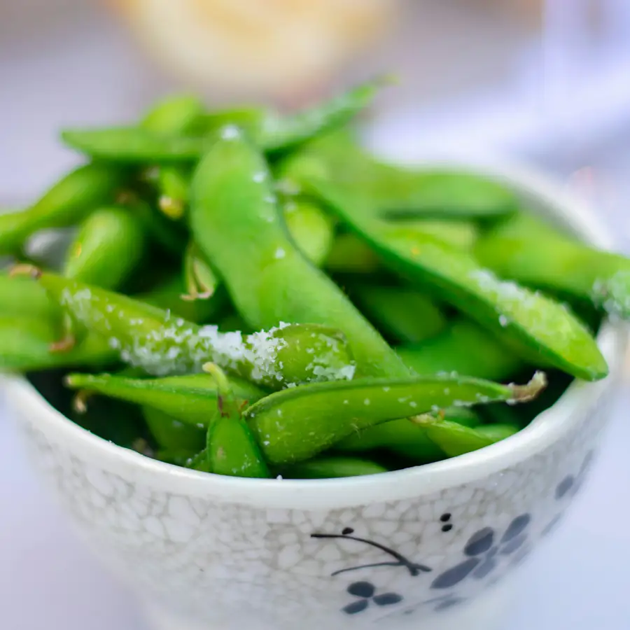 Bowl of salted edamame pods