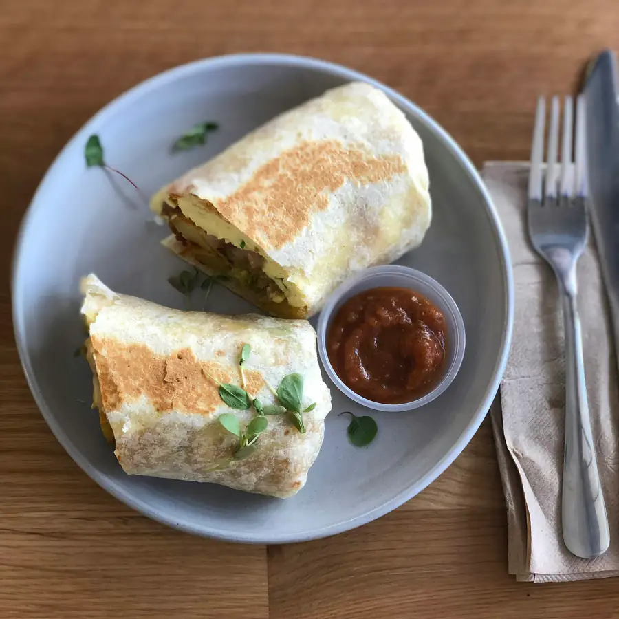 Halved breakfast wrap on a plate