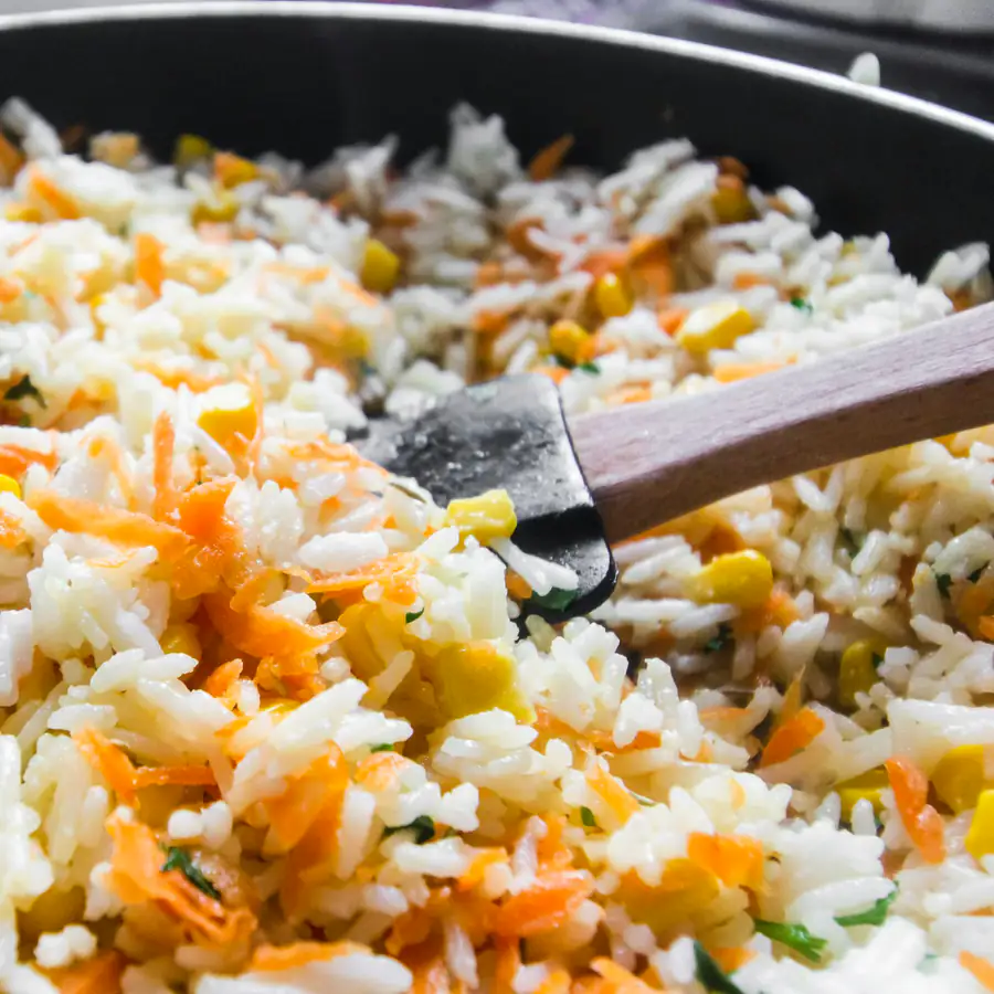 Pan of egg fried rice with carrot, peas and sweetcorn