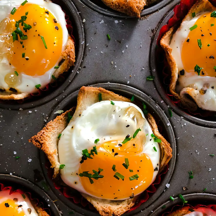 Baked eggs in toast cups in a muffin tin