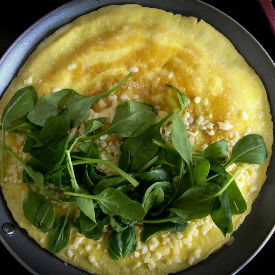 Omelette topped with fresh leaves
