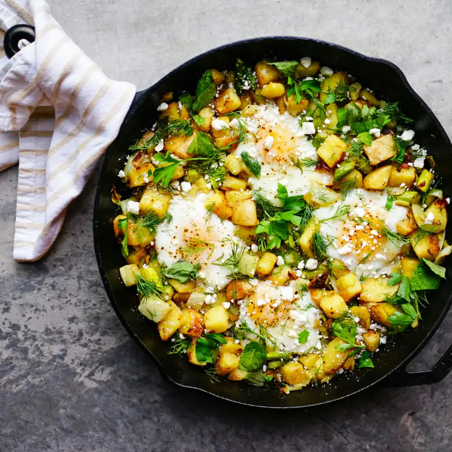 Skillet breakfast hash with eggs and greens
