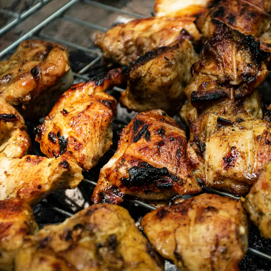 Grilled chicken pieces fresh off the grill