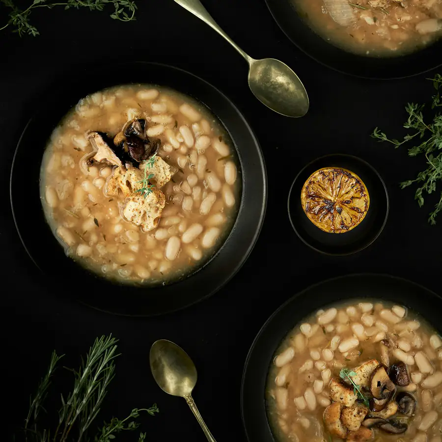 Bowls of barley and bean soup with a dried chilli