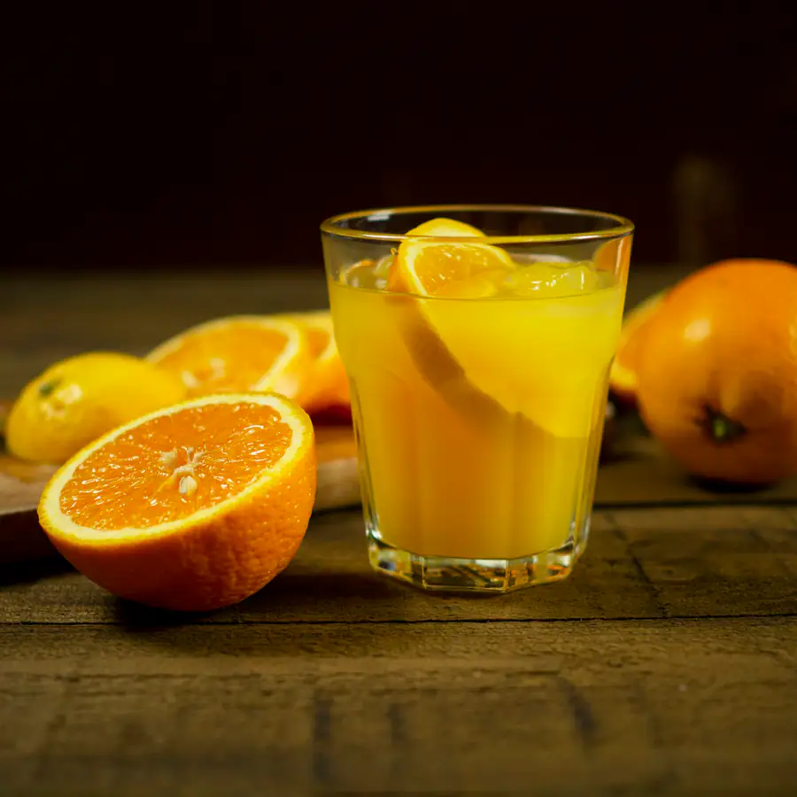 Glass of orange drink with orange slices