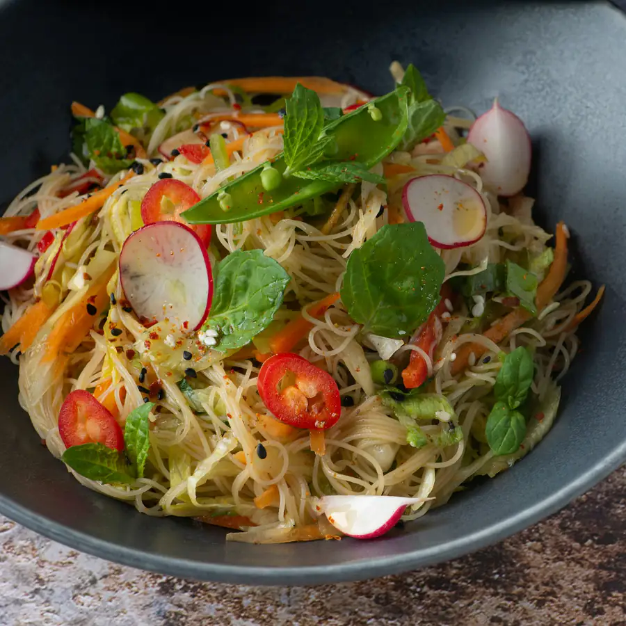 Rice noodle salad with herbs, tomato and radish