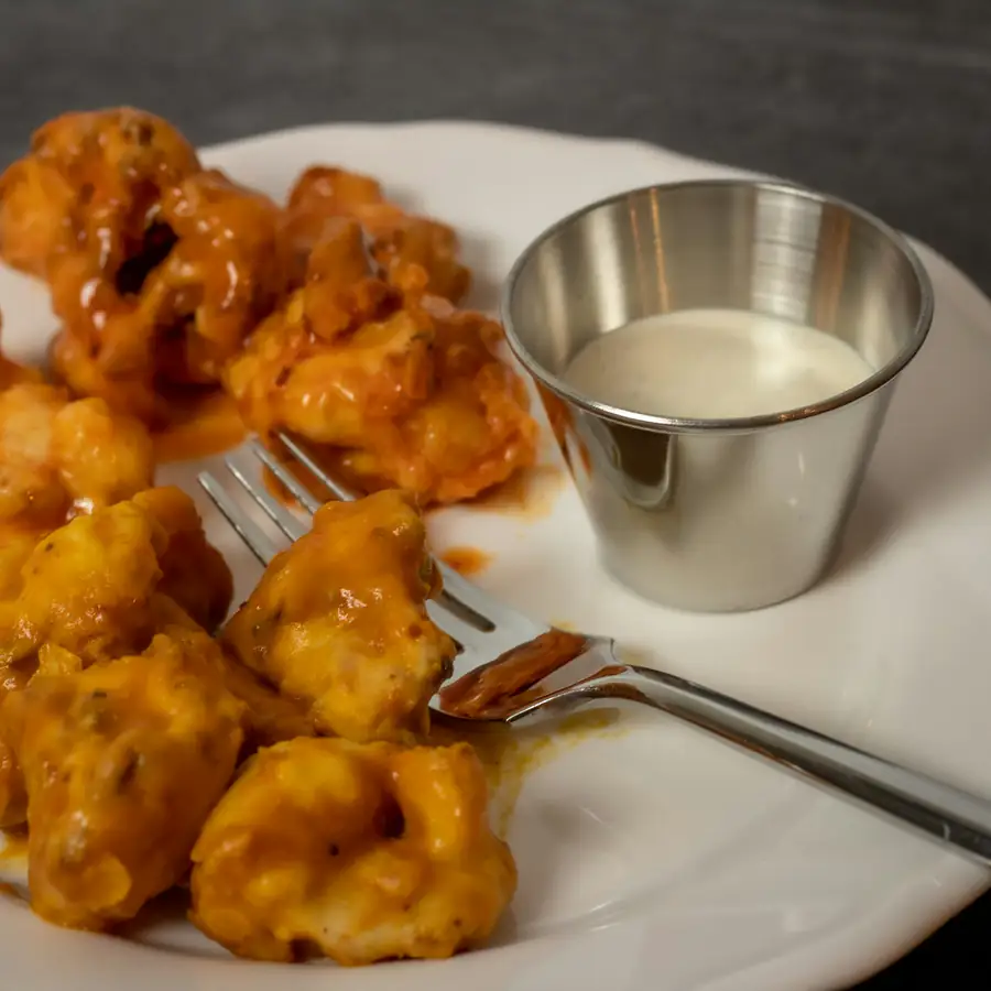 Crispy buffalo cauliflower bites with a dip