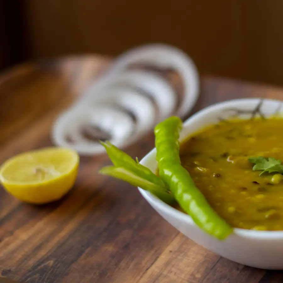 Bowl of lentil dal with a green chilli