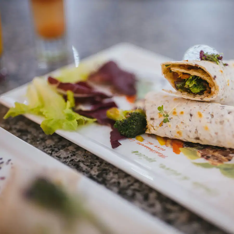 Sliced filled tortilla roll showing ham and broccoli