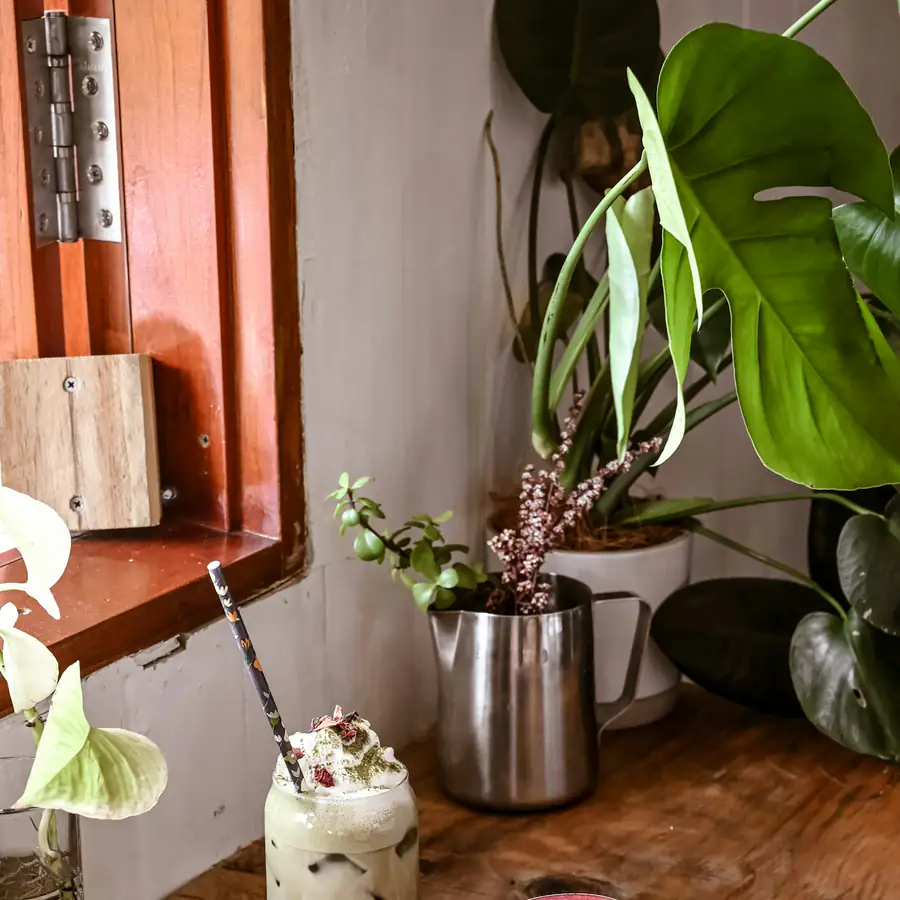 Cup of pink beetroot latte on a wooden table