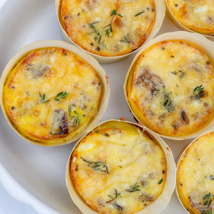 Baked egg muffins with herbs in a muffin tin