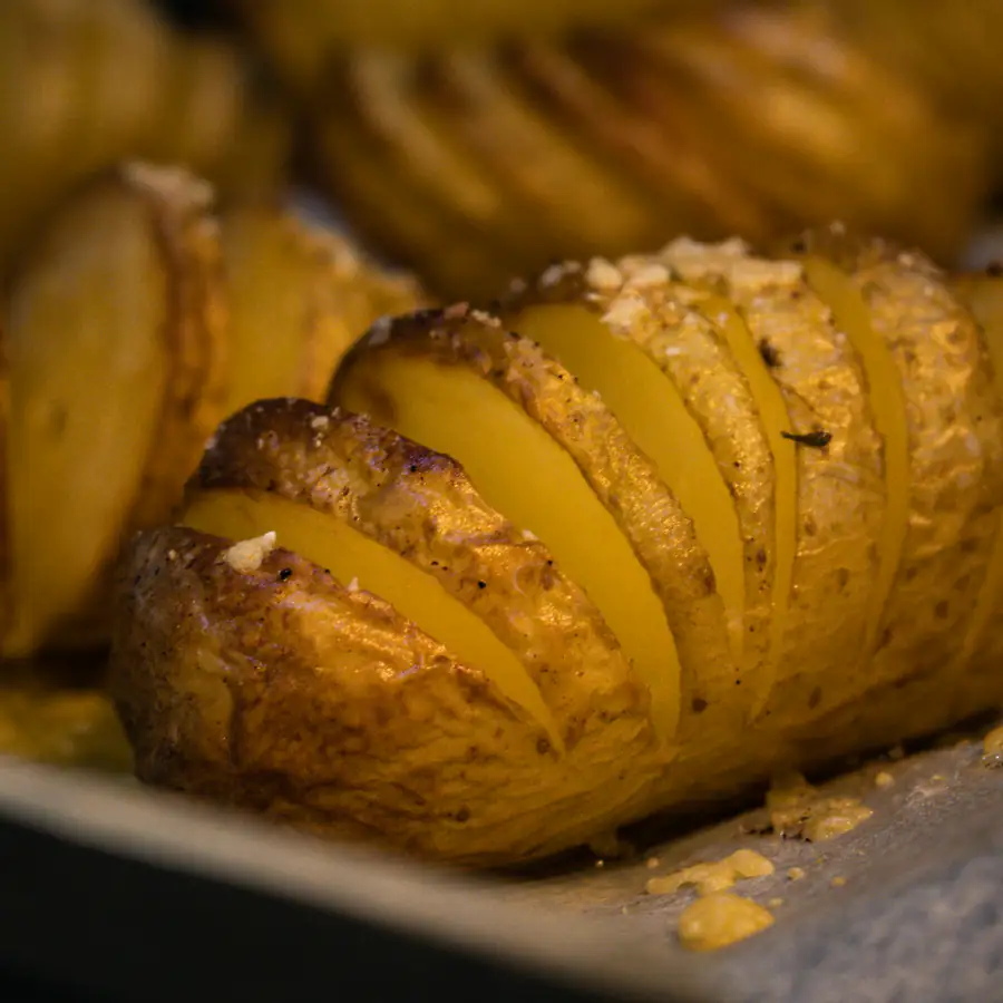 Split baked jacket potato with a golden topping