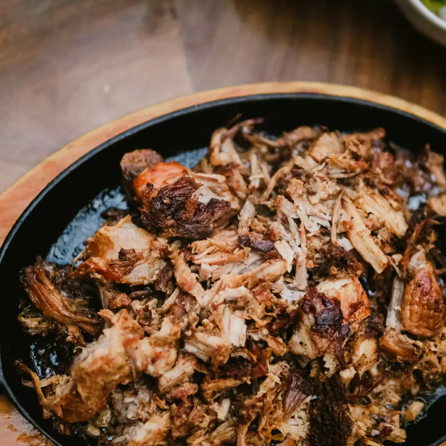 Black pan of shredded pulled pork