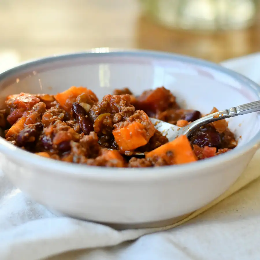 Bowl of lentil and bean stew with carrot