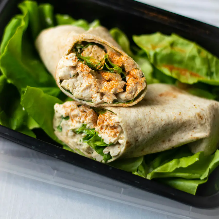 Halved wrap with grilled filling and salad leaves