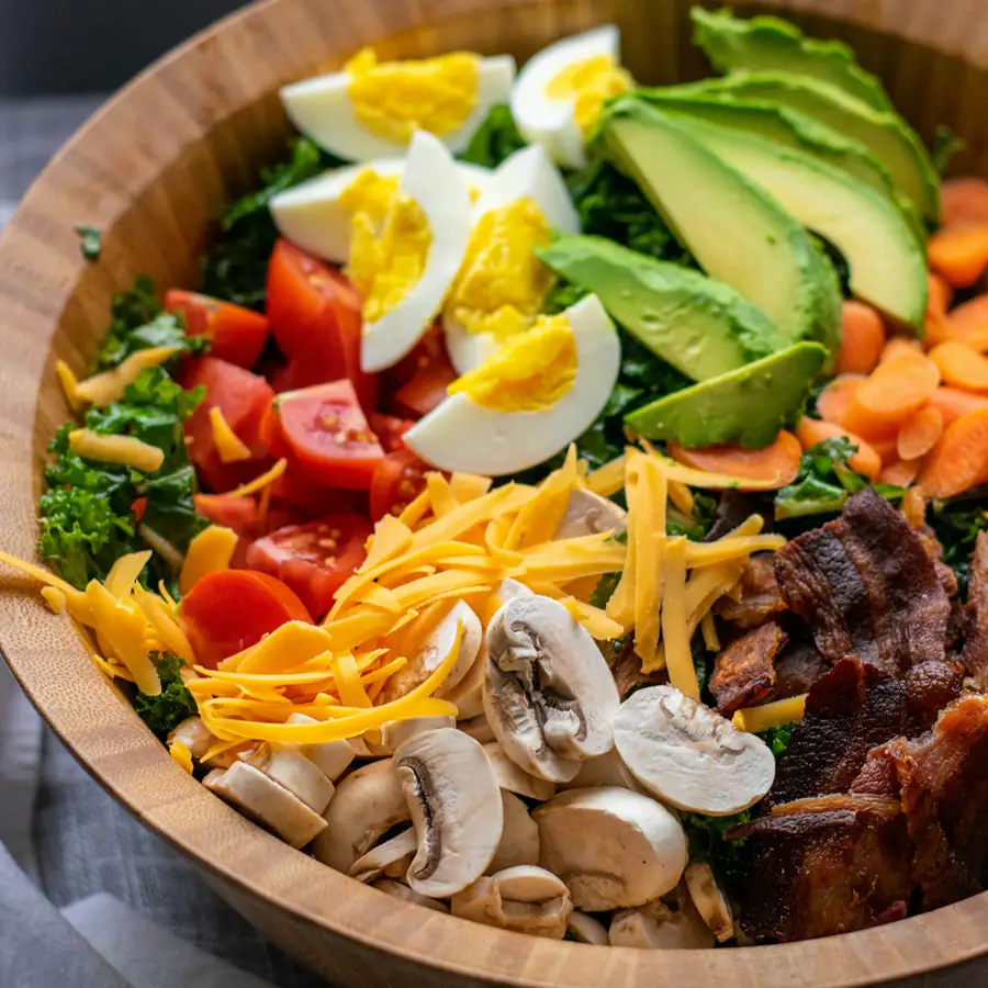Loaded salad bowl with egg, avocado, cheese and vegetables