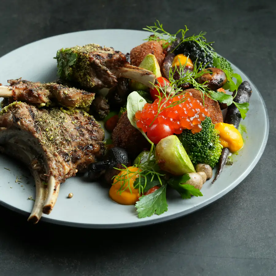 Grilled lamb chops with green vegetables on a plate