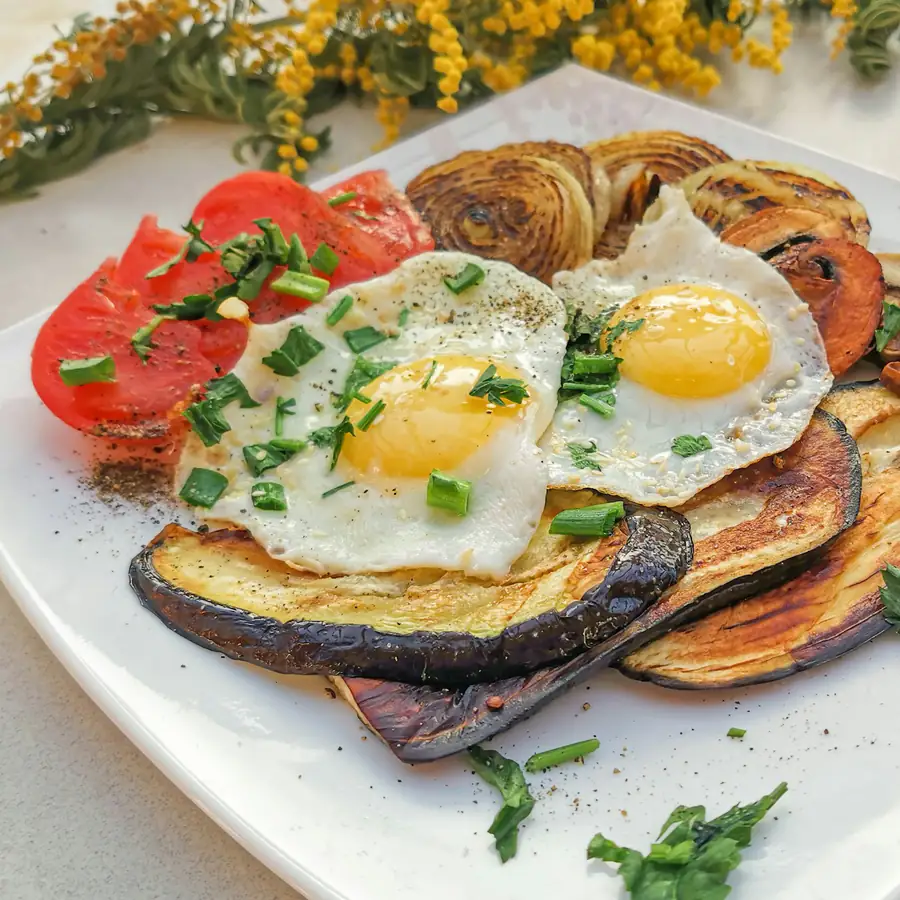 Fried eggs over potatoes and vegetables