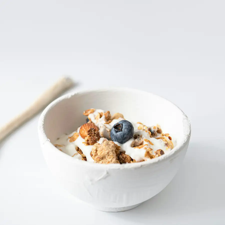 Bowl of wholegrain cereal with yoghurt and blueberries