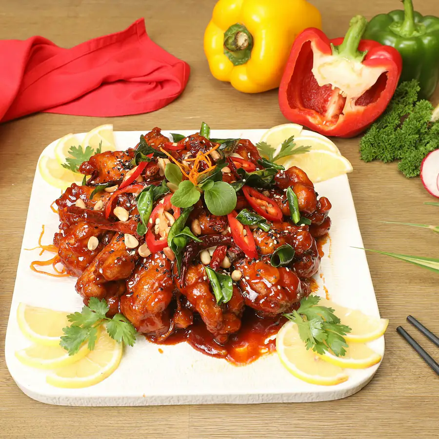 Plate of crispy chilli chicken with peppers