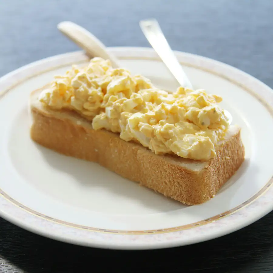 Soft scrambled eggs piled on toast