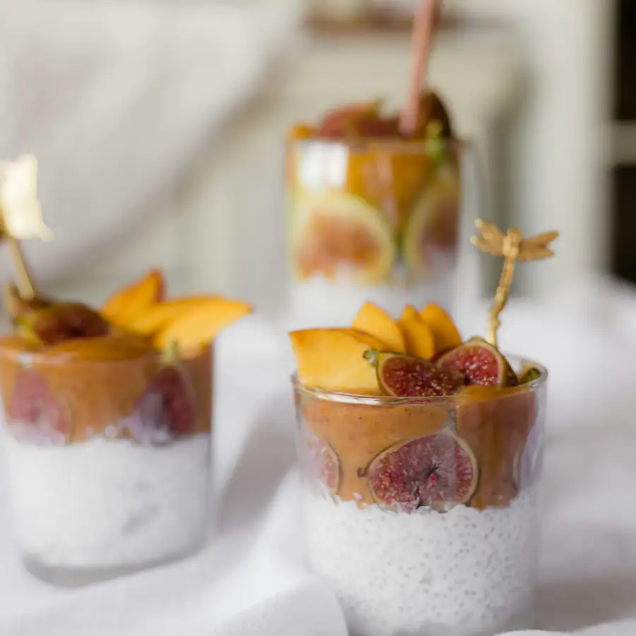 Glasses of chia pudding topped with fruit