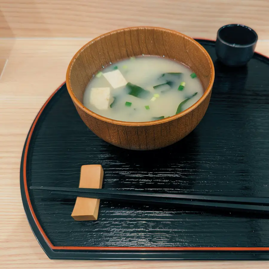 Bowl of miso broth with tofu and seaweed
