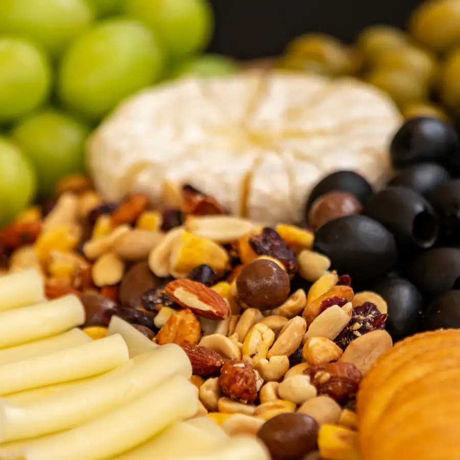 Snack board of olives, nuts and crackers
