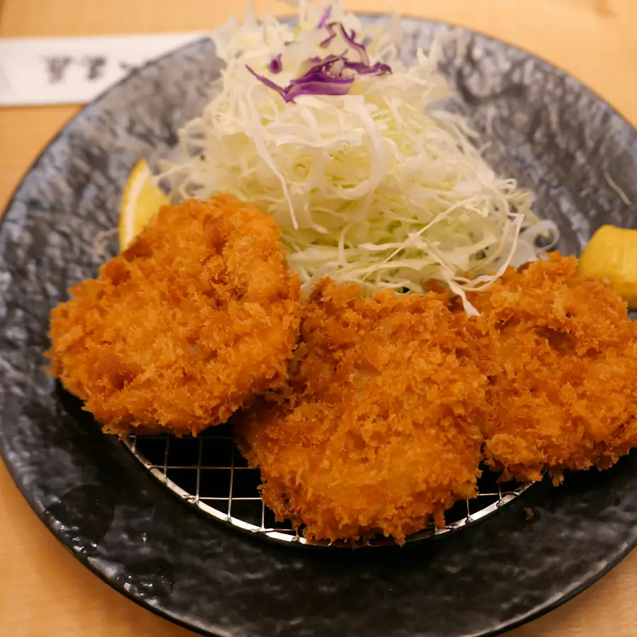 Bowl of breaded golden cutlets with shredded cabbage