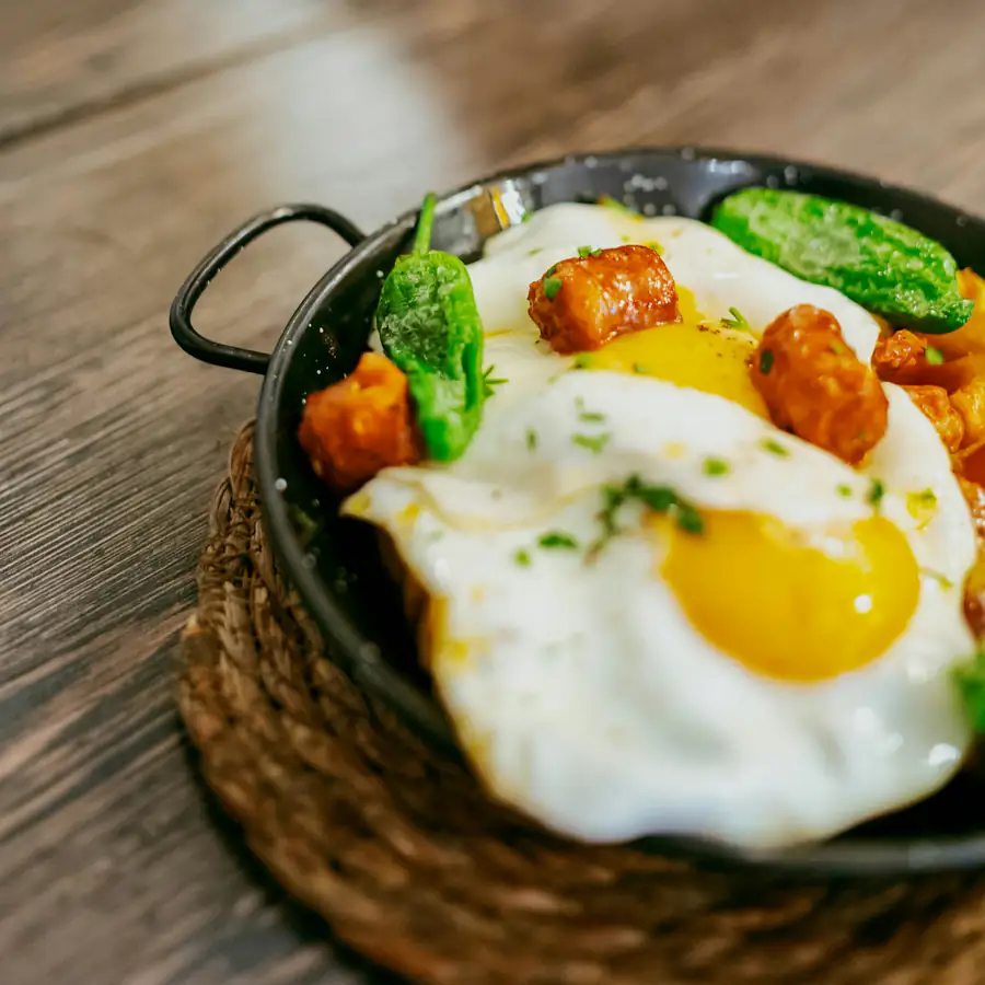 Skillet of fried eggs with peppers